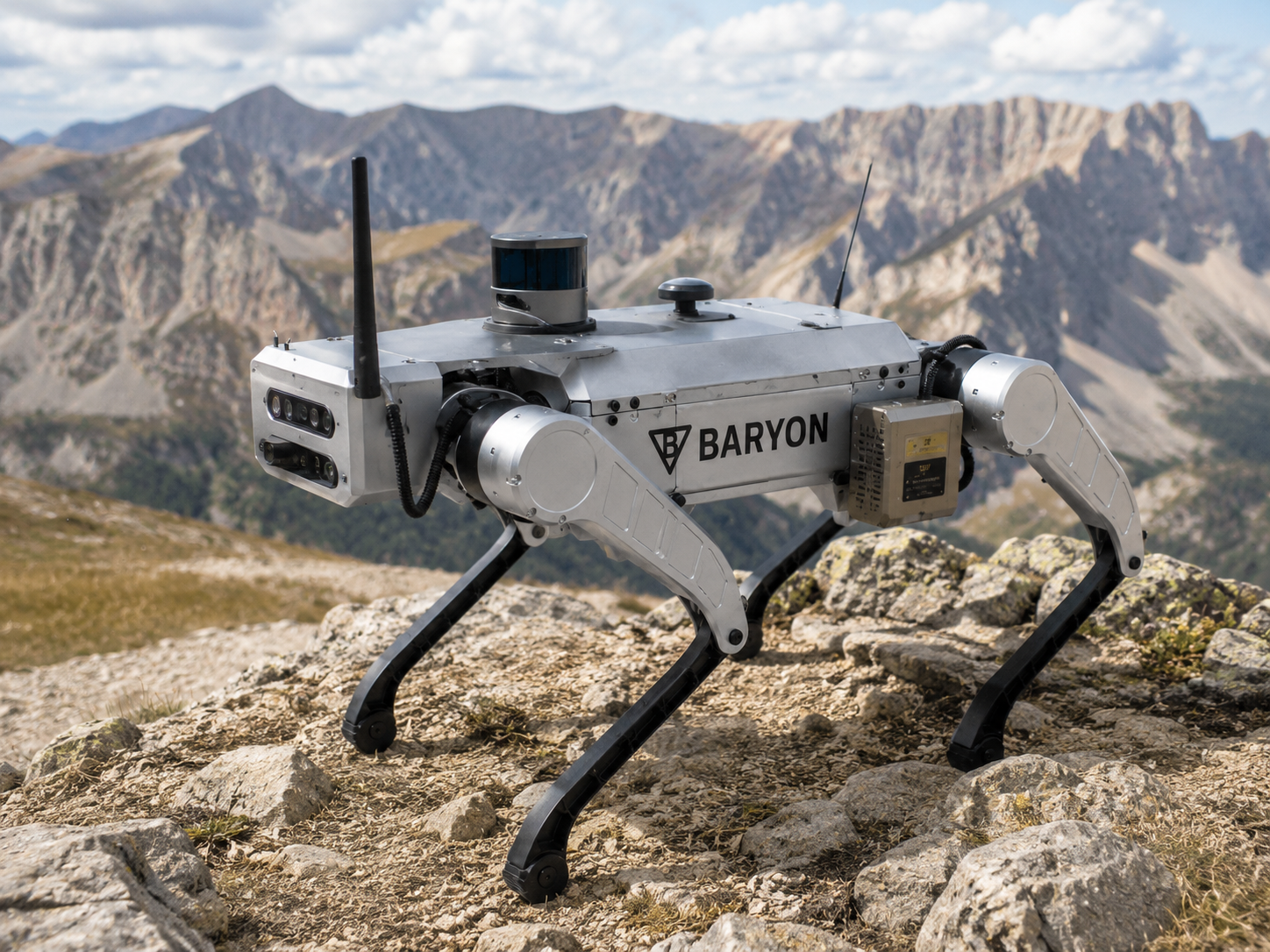 Baryon autonomous quadruped robot standing on a rocky alpine plateau in the Big Horn Mountains